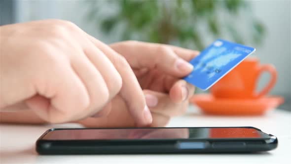 Hands Enters Credit Card Details Into  Smart Phone To Buy.