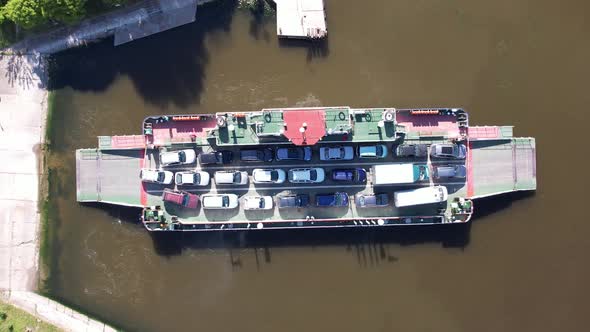 top down view of ferryboat transferring cars. Ferry transfers cars and passengers to the other side alt