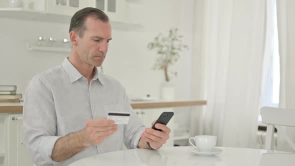 Middle Aged Man Making Successful Payment on Smartphone alt