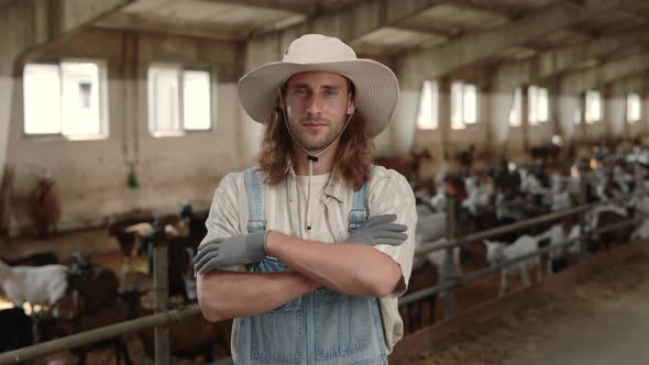 Young Greeder in Uniform and Hat Posing at Farmhouse alt