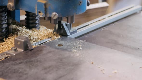 Process of drilling holes in a furniture board