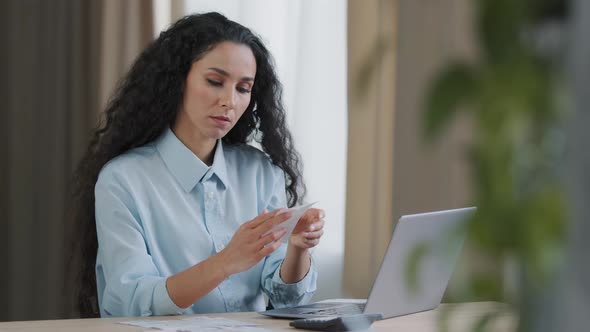 Focused Young Entrepreneur Female Business Woman Accountant Holding Paper Notes Making Electronic alt