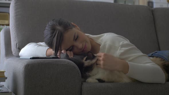 Woman cuddling her cat