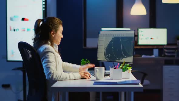 Tired Engineer Analizing Prototype of 3D Model of the Plant Yawning Working Overtime alt