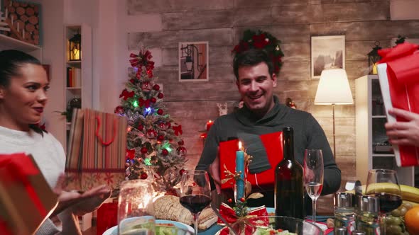 Cheerful Atmosphere of Big Family Exchanging Presents alt