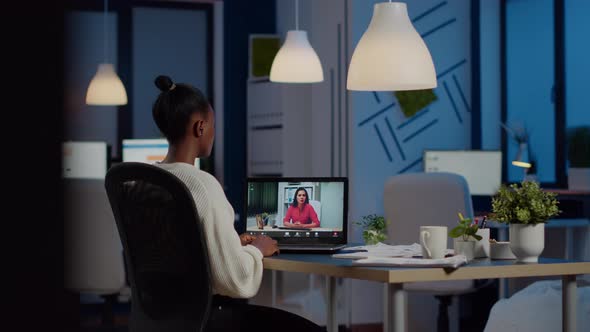 African Freelancer Working Remotely Discussing with Woman Partner Online alt