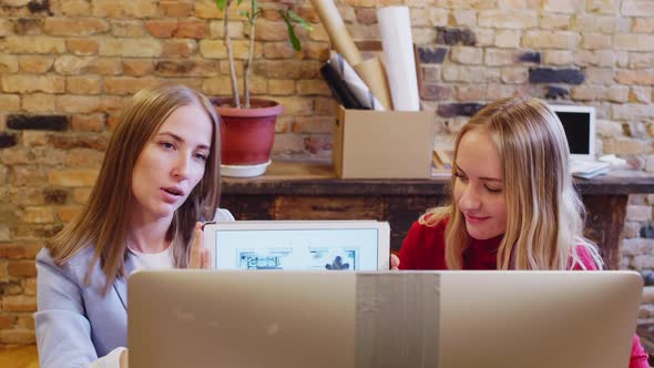 Female Colleagues Showing Interior Project on Tablet via Web Call