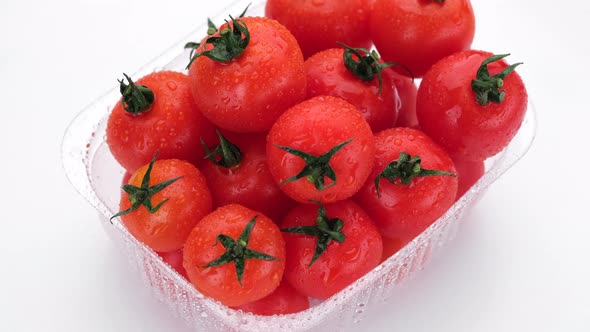 Fresh red tomatoes in container for delivery or sale on white background. 4K UHD video alt