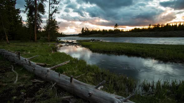 Time lapse after the sun has set over forest along river in Yellowstone alt