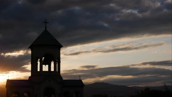 Silhouette of Bell Tower in the Rays of Sunset
