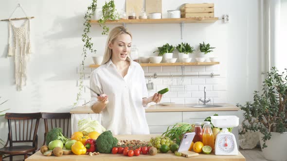 Woman Stands at a Table with a Lot of Vegan Food Ingredients She Talks About Proper Nutrition at alt