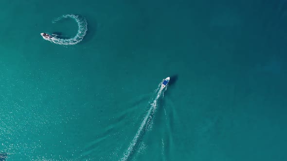 Following Little Fishing Boat In Mediterranean Sea. Overhead view alt