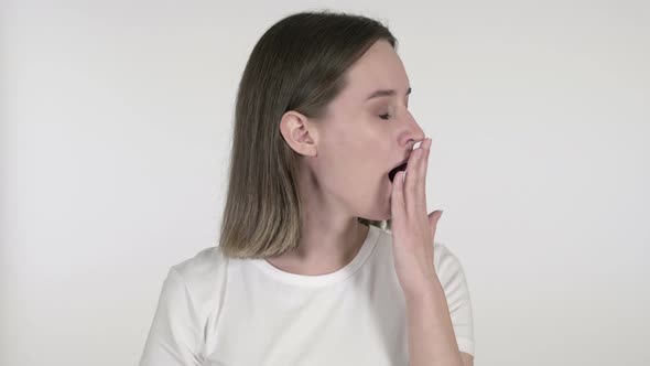 Young Woman Yawning and Stretching Body on White Background alt