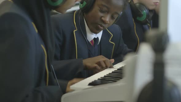 CU TU Schoolgirl and schoolboy learning music on piano