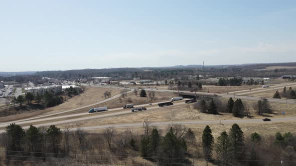 Fast paced freeway crossroads and bridge in open country with blue sky and mounts.