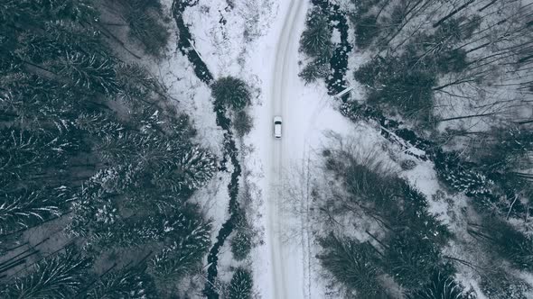 Overhead Top View Car Moving By Snowed Trail Road By Mountains Forest alt