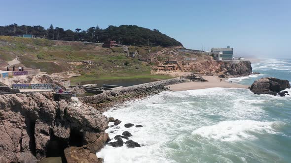 Close-up push-in aerial shot of the remains of the Sutro Baths at Land's End, San Francisco. 4K alt