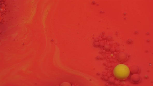 Amazing Red and Yellow Bubbles of Paint on the Oil Surface. Paint in Oil alt