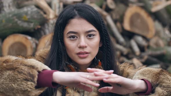 Asian Young Woman Covers Her Face with Her Hands with Painted Eyes on Her Palms alt