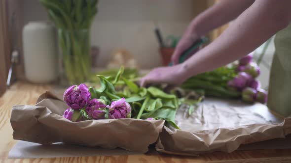 Woman Seller Cuts Stems of Bright Flowers with a Secateurs