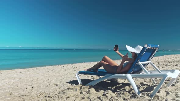 Girl Taking Fun Selfie Picture on Beach Vacation alt