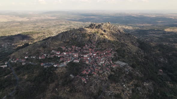 Panoramic view of Monsanto Village against medieval hilltop castle, Portugal