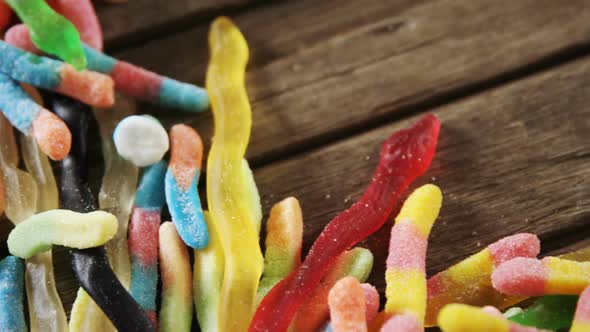 Gummy candies on a wooden table 4k alt