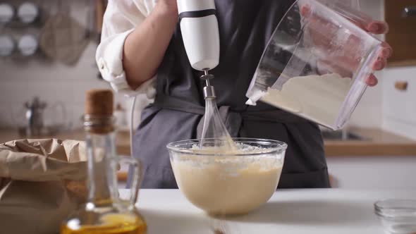 The Chef Kneads The Dough With An Electric Blender Adding Flour. Kneading Dough Preparation alt