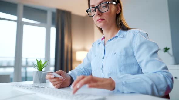 Female Hands Typing Credit Card Number on Computer Keyboard alt