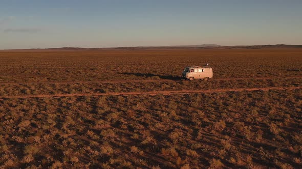 Aerial View Off Road 4X4 Car Driving Along Dirt Road Among the Desert alt