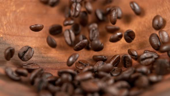 Roasted Coffee Beans Rolling in Wooden Bowl in Super Slowmotion alt