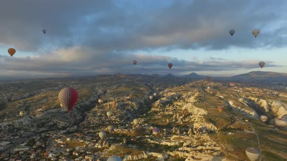 Aerial Hot Air Balloons Flying Over Hoodoos and Fairy Chimneys in Goreme Valley Urgup, Turkey alt