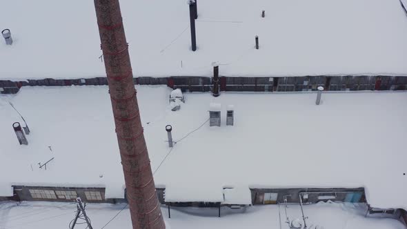 Brick Facade of the Industrial Building Against the Background of the Winter Landscape