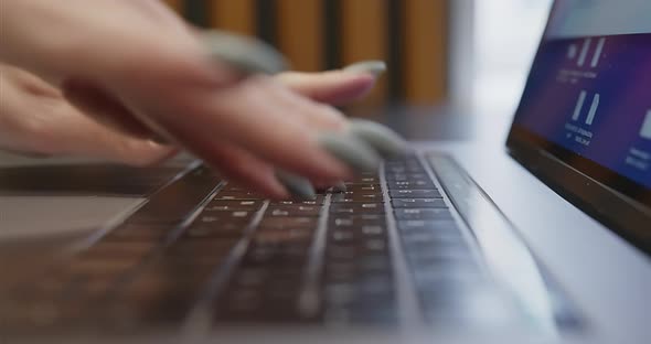 Closeup of Female Fingers with Manicure Typing Text on Laptop Keyboard alt