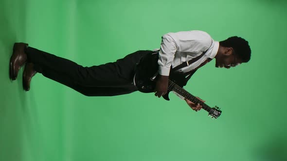 Portrait of Young African American Man Smiling and Playing Electric Guitar alt