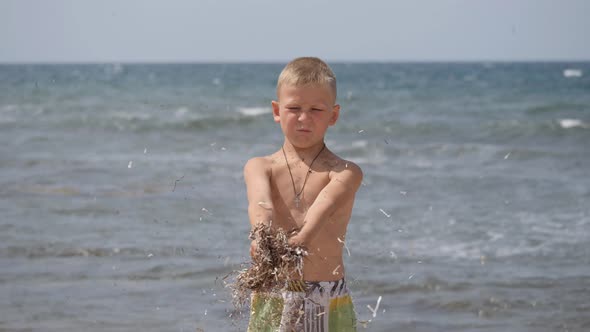 Beach Summer Vacation. Children's Emotions. The Child Develops Tinsel in the Wind. alt