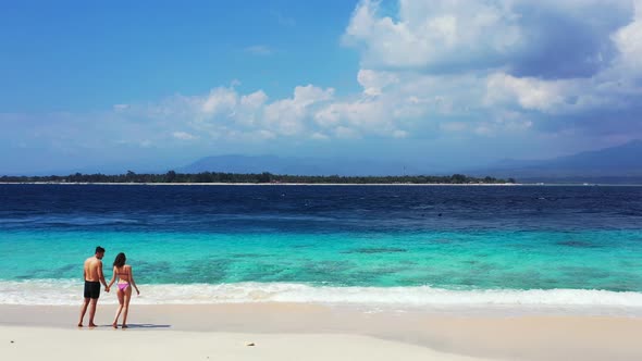 Beautiful man and woman married on vacation enjoy luxury on beach on sunny white sandy background 4K alt