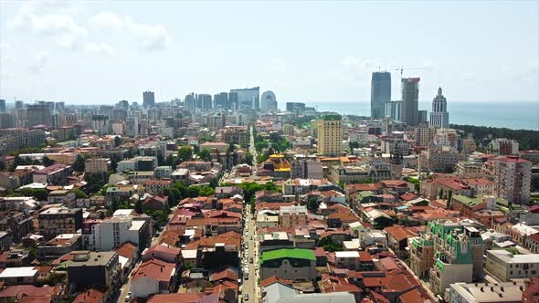 Aerial drone view of Batumi, Georgia. Old and modern buildings, greenery, roads, Black sea alt