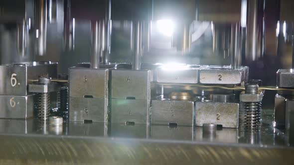 A large industrial punch press forming sheet metal parts alt