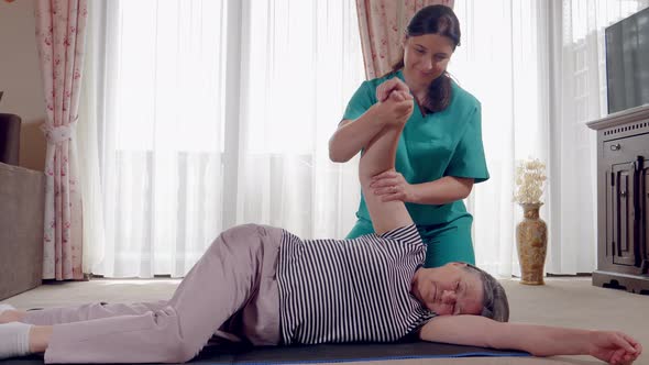 Senior During Rehabilitation with Physiotherapist After an Arm Injury