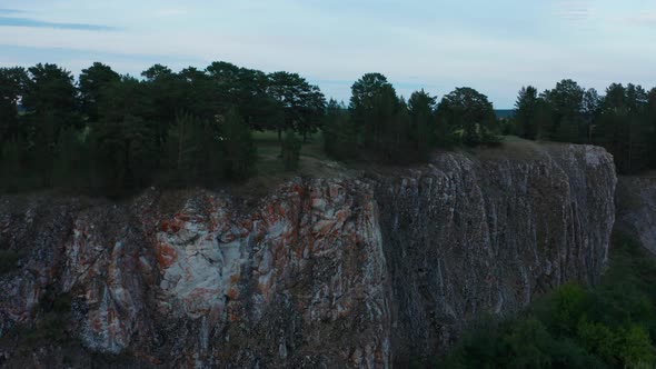 Aerial View of a Car on the Edge of a Cliff alt