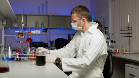 Young Scientist Mixing Colored Liquids