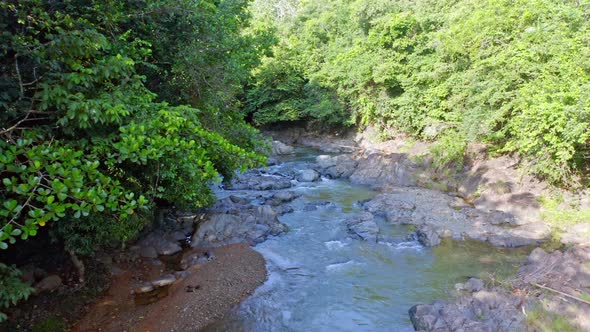Aerial forward low altitude over Higuero creek at La Cuaba in Dominican Republic alt
