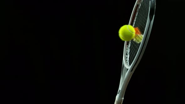Super Slow Motion Detail Shot of Hitting Tenis Ball Containing Color Powder By Racket at 1000 Fps alt