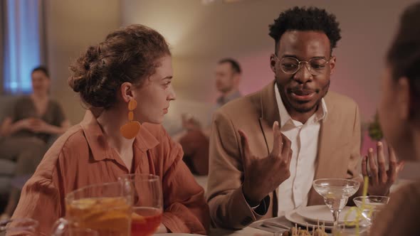 Afro American Man Talking at Friends Dinner Party alt