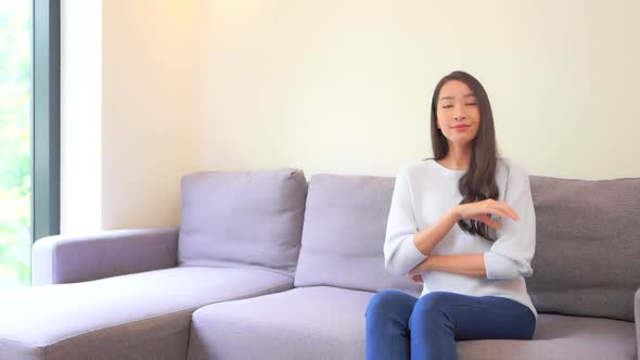 Asian woman sit on sofa and relax