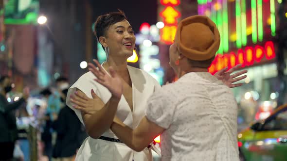4K Asian lgbtq guy friends in woman clothes meeting together in the city at night. alt