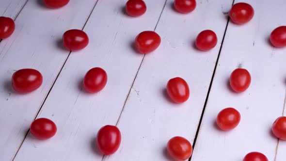 Background or Composition of Rotating Cherry Tomatoes on White Wooden Boards Healthy Food Concept