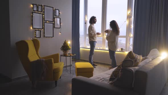 Bearded Guy Gives Present to Long Haired Girlfriend in Room