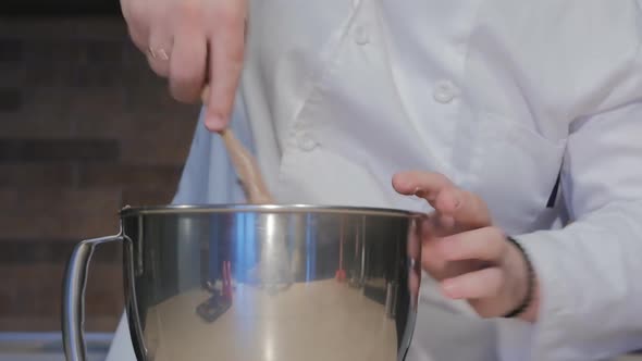 a Brutal Confectioner a Caucasian Man Kneads the Dough in a Stainless Bowl with a Spatula